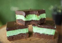 Chocolate Mint Brownies Three Chocolate Mint Brownies Stacked on a cutting board, showing the brownie, green filling layer and chocolate topping layer.