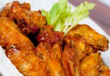 Honey-Glazed Wings Honey Glazed Chicken Wings in bowl with celery.