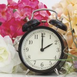 Spring forward to save energy? Not so fast… clock and flowers