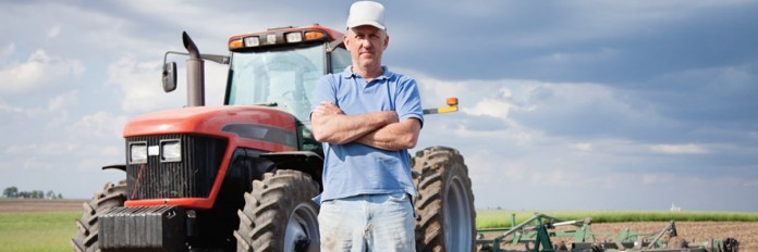 Farmer standing by tractor