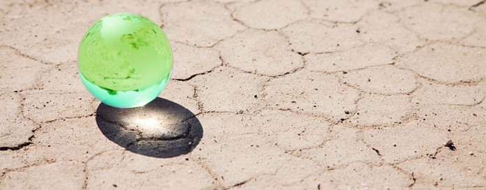 marble globe on parched ground