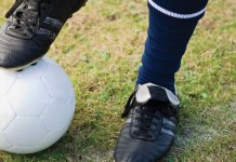 Coaches turn boys to men boy's foot on soccer ball
