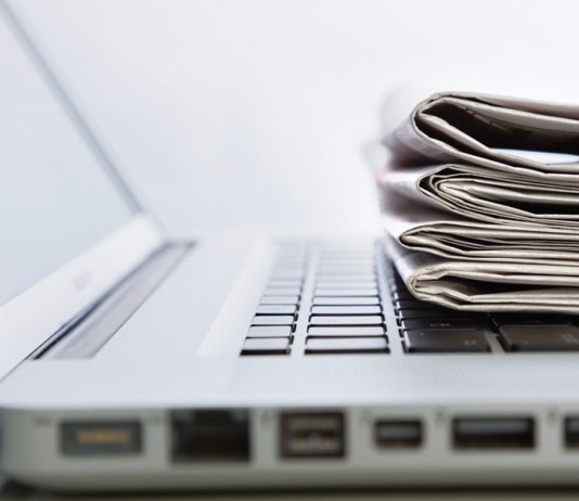 laptop and newspapers