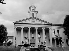 The tall clock tower and looming white pillars of the Lawrence County, Pennsylvania Courthouse stands tall against the cloudy sky as another day in Drug Court begins.