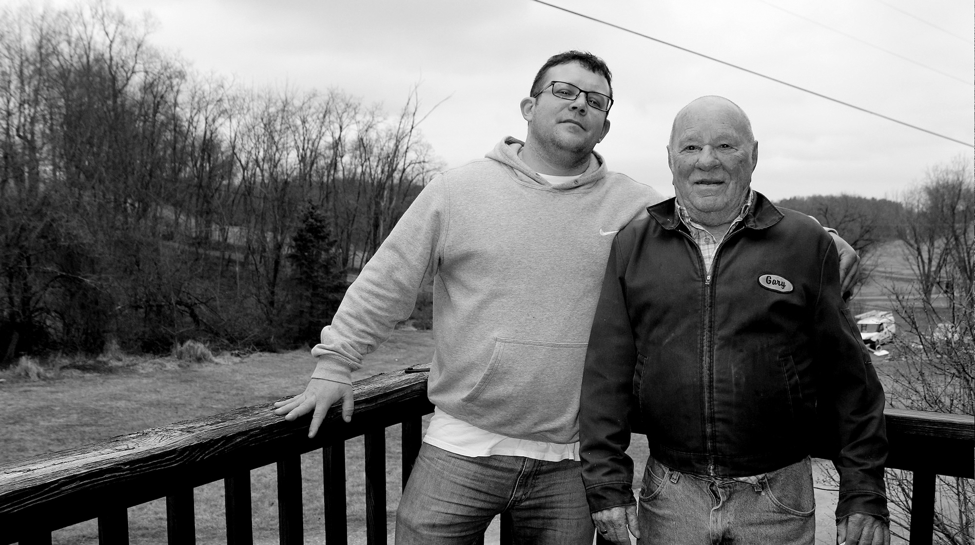 David Stanley stands next to his dad on their porch overlooking the scenic farmland that surrounds their home.