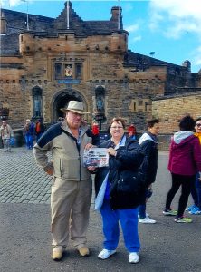 The Larricks standing in front of Edinbugh Castle in Scotland with their Farm and Dairy