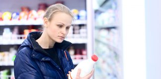 Woman buying milk at the store before a snowstorm