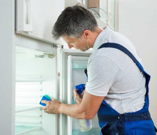 Toss it? Is food safe to eat after a flood? Man cleaning fridge