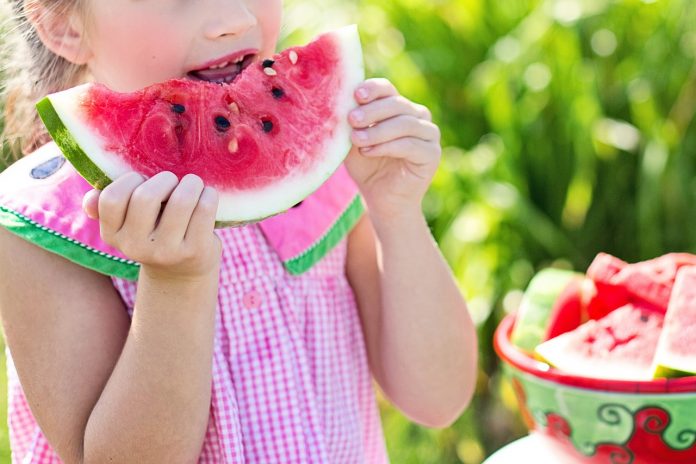 little girl eating watermelon