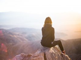 girl sitting on mountain