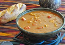 West African Peanut Soup A bowl of West African Peanut Soup with an onion, and ladel in the foreground