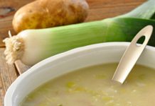 Creamy Potato Leek Soup A bowl of Creamy Potato Leek Soup, a leek and poato are in the background and a bulb of garlic is in the foreground