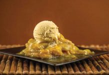 Slow Cooker Peach Cobbler A plate of Slow Cooker Peach Cobbler with a scoop of vanilla ice cream on top