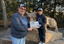 Visiting the Penn State with the Halls Dennis Hall standing in front of the Nitany Lion Statue at Penn State with his nephew, Jake and his Farm and Dairy.