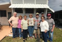 Vacationing in Palmetto, Florida Vacationing in Palmetto, Florida a group of friends stands in front of a window with an awning