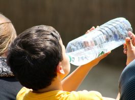 boy drinking from water bottle