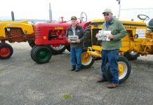 Riding antique tractors in Mackinaw City with Rufner and Moore
