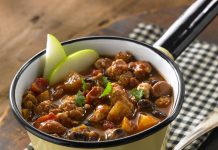 Apple Turkey Chili A bowl of Apple Turkey Chili garnished with two apple slices.