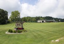 Rural businesses, professionals face limited broadband access A sign for M&M Feed Supply with the store behind it.