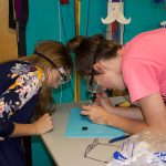 Breaking the cycle of limited broadband access, knowledge 4-H'ers work on a soldering activity at a club meeting.