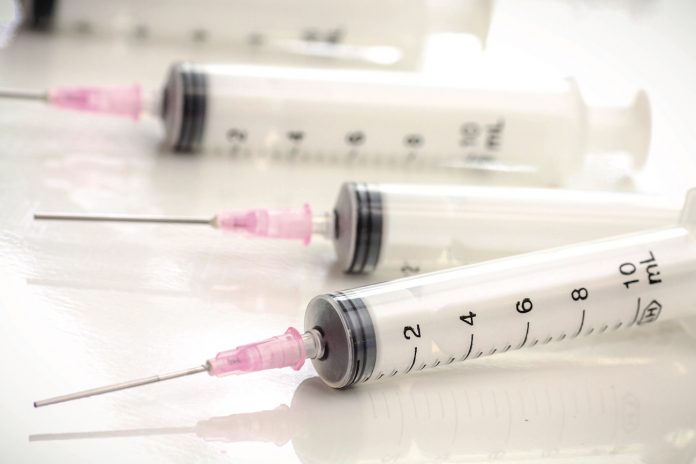 syringes and needles laying on table