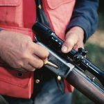 Informational meeting on March 3 for new youth rifle team hunter loading rifle orange vest