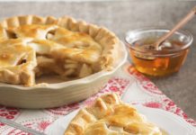 Queen Bee Apple Pie A slice of Queen Bee Apple Pie on a white plate.