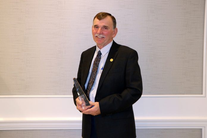 Russell Kiko holds his award.