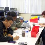 Cleveland school seeks agriculture opportunities for students Two students and a teacher work on a soil experiment.