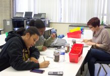 Cleveland school seeks agriculture opportunities for students Two students and a teacher work on a soil experiment.