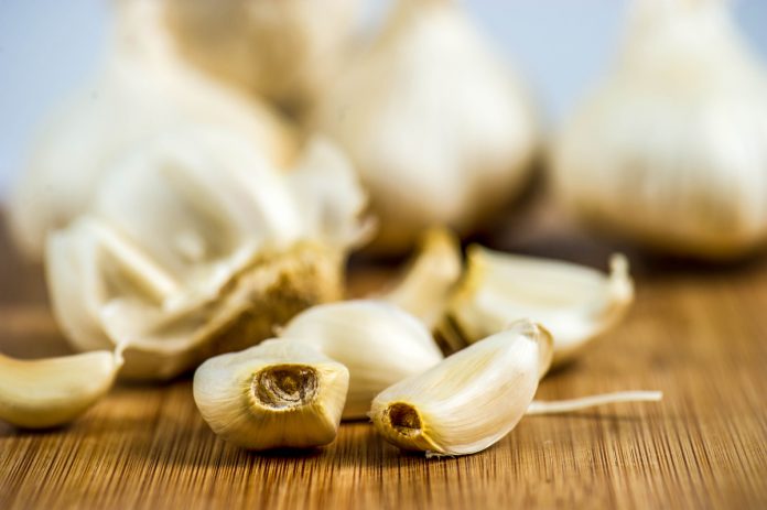 Garlic cloves on a cutting block.