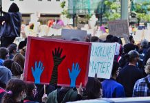 Red, white, blue and black in the USA black lives matter sign at a George Floyd protest