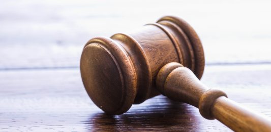 Columbus woman charged in online auction bid-rigging scheme gavel on table