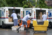 Postal Service slowdowns could hurt rural residents during election time Letter carriers load mail trucks for delivery.