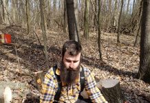 Hitting the ground running: Ohio Tree Farm Inspector of the Year is new, but not green A man kneels next to part of a tree on the ground and measures it with a tape measure.