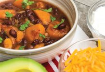 Autumn Sweet Potato Chili Bowl of Sweet Potato Chili with Avocado and Cheddar cheese on the side