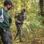 A 30-year investment: New ODNR wildlife officers get on-the-ground training Two wildlife officers walk through the woods.