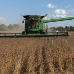 Bipartisan Policy Center, Vilsack discuss climate policy in ag A combine harvesting soybeans in a field.