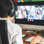 Ohio broadband grant program opening for applications A person sits at a computer, video conferencing with multiple people.