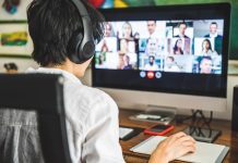 Ohio broadband grant program opening for applications A person sits at a computer, video conferencing with multiple people.