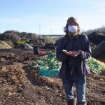 Practicing resurrection: Clevelanders turn food waste into soil A man stands in front of a composting facility.