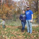 Home is where the mushrooms, microgreens are for Lorain Co. family A woman and a man stand in front of a garden in the fall while a girl and a boy play in the background.