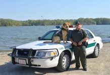 ODNR officer died in line of duty An ODNR officer and K-9 stand in front of a car.