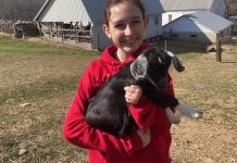 Female veteran’s small business gives boost to other female vets girl with goat kid