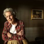 First female state 4-H leader Mildred Fizer celebrates 100th birthday A photo of Mildred Fizer, standing in a room in a red shirt.