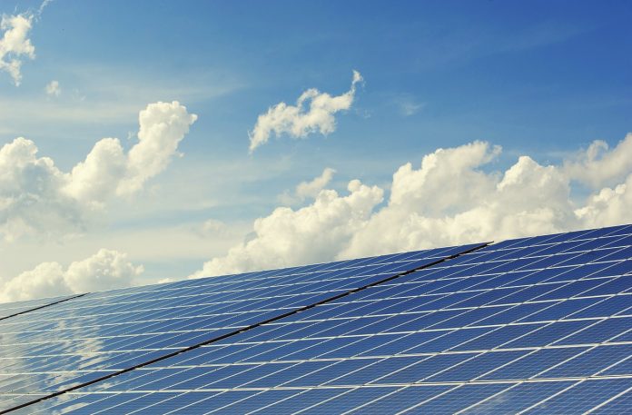 solar panels with cloud in the background