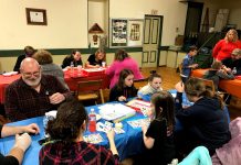 Growing the Grange: Oldest US ag group needs to attract new generation people play board games together