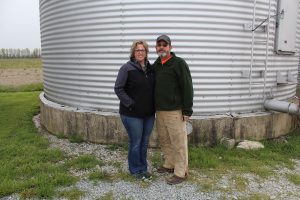 hawks stand in front of grain bins