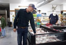 Rohr focuses on whole meat supply chain with Honeytown Meats A man looks over cuts of meat in a store.