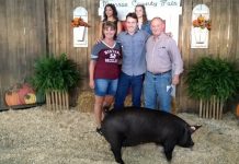 Junior fair sales bring out best in rural communities people standing with pig